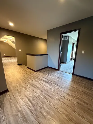 an empty room with a empty space and windows