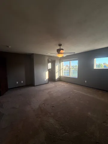 a view of empty room with yard and fireplace