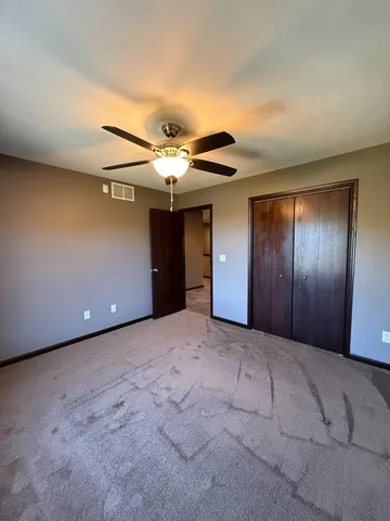 a view of wooden floor and windows in a room