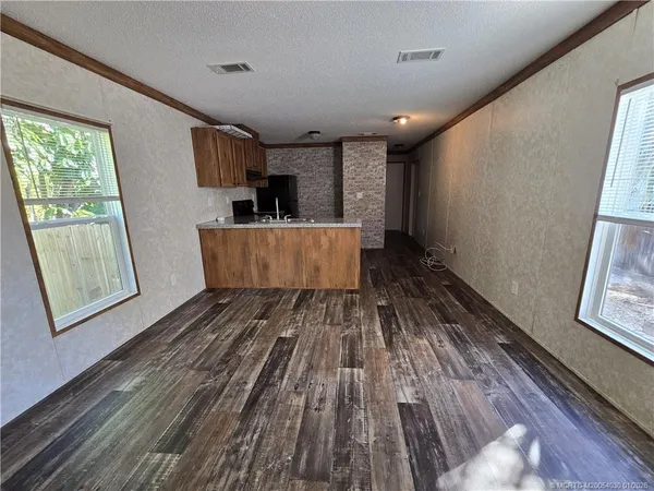 a view of kitchen with sink and wooden floor