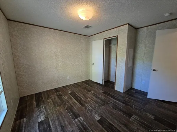 a view of a room with wooden floor