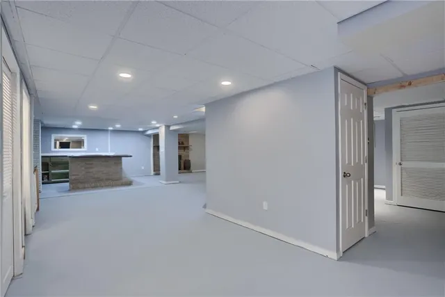 a view of a kitchen with a sink and a large window