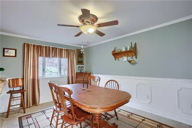 a dining room with furniture a window and a chandelier