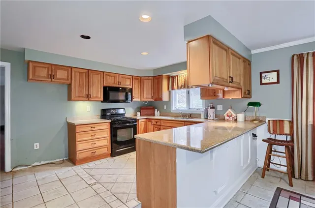 a kitchen with stainless steel appliances granite countertop a refrigerator a stove top oven a sink and dishwasher