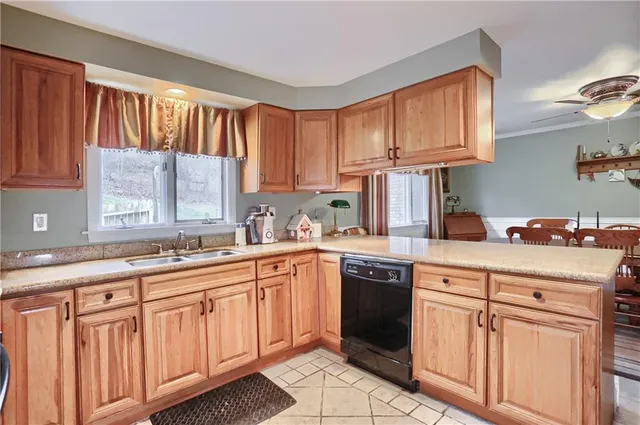a kitchen with cabinets appliances a sink and a window