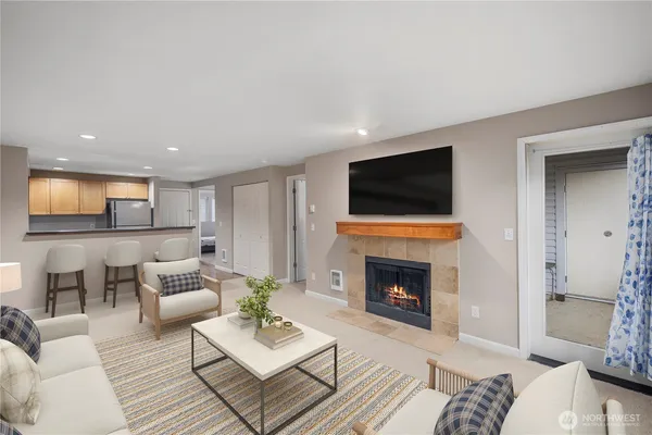 a living room with furniture a fireplace and a flat screen tv
