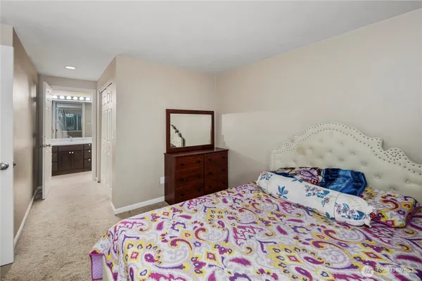 a bedroom with a bed and a dresser