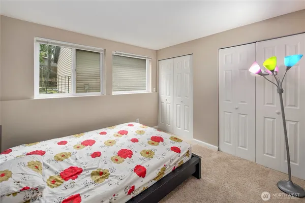 a bedroom with a bed and a window