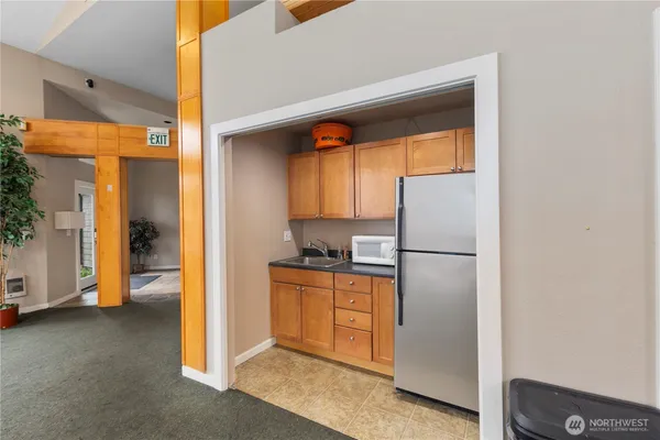 a kitchen with a refrigerator and a stove
