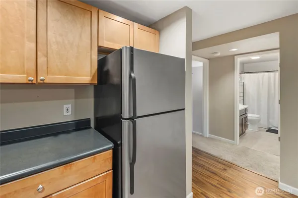 a white refrigerator freezer and a stove sitting inside of a kitchen