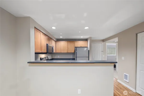 a view of kitchen with kitchen island microwave and stove