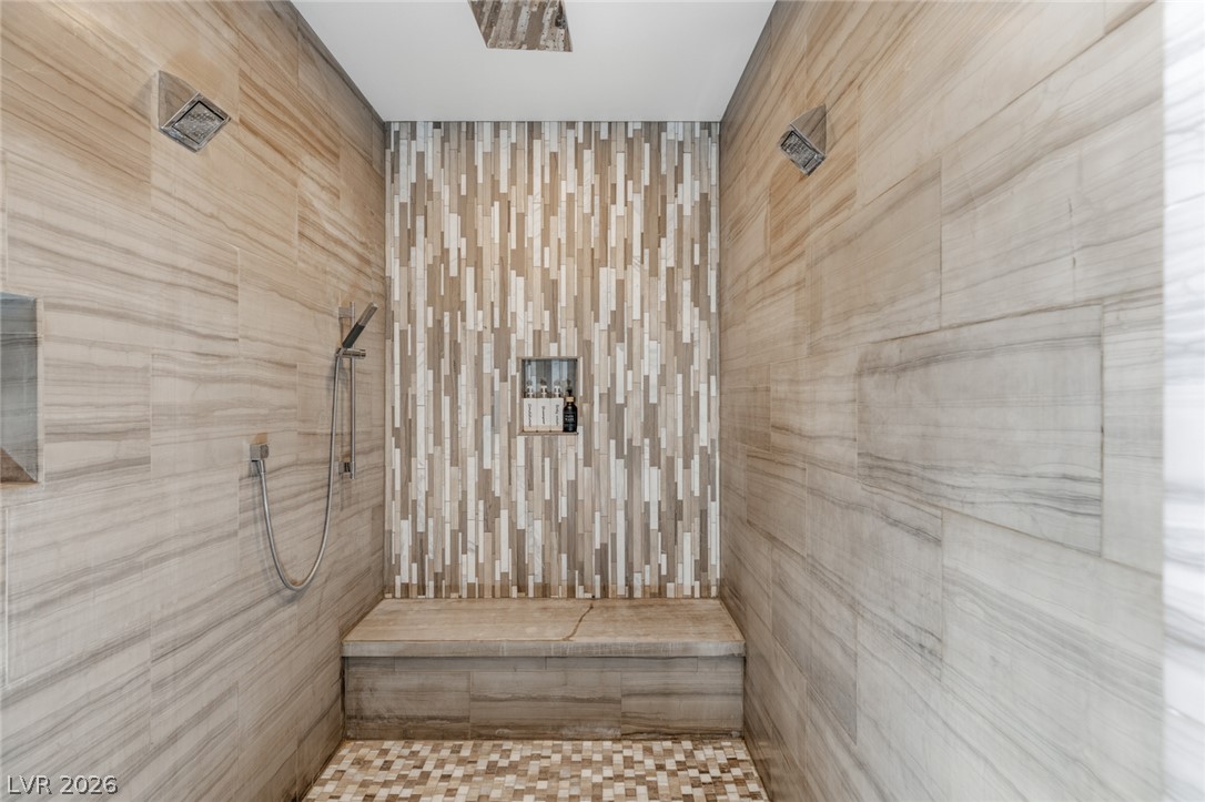 5 Crystal Tree Pass Henderson, NV 89052 - Photo 23 of 67 Experience luxurious showering with dual rain heads and elegant tiled walls, offering a serene escape.