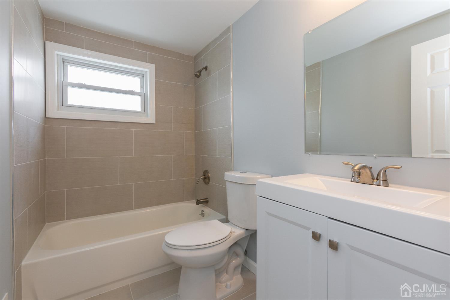 70 Westminster Road Colonia, NJ 07067 - Photo 11 of 12 a bathroom with a sink a toilet and shower