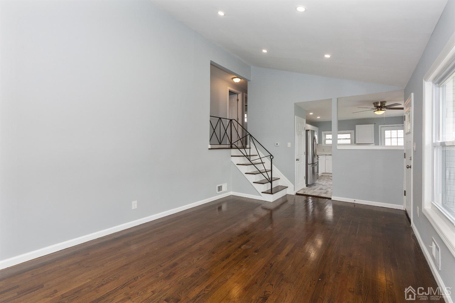 70 Westminster Road Colonia, NJ 07067 - Photo 3 of 12 wooden floor in an empty room with wooden floor and stairs