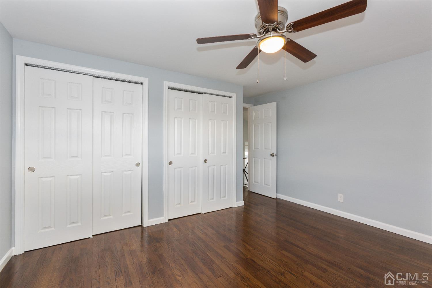 70 Westminster Road Colonia, NJ 07067 - Photo 10 of 12 an empty room with wooden floor fan and windows