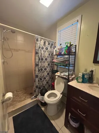a bathroom with a toilet a sink and a shower