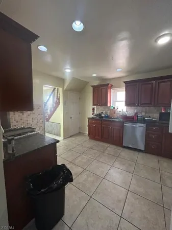 a kitchen with stainless steel appliances granite countertop a stove and a refrigerator