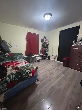 a bedroom with a bed and a tv