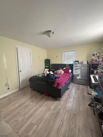 a bedroom with bed and window