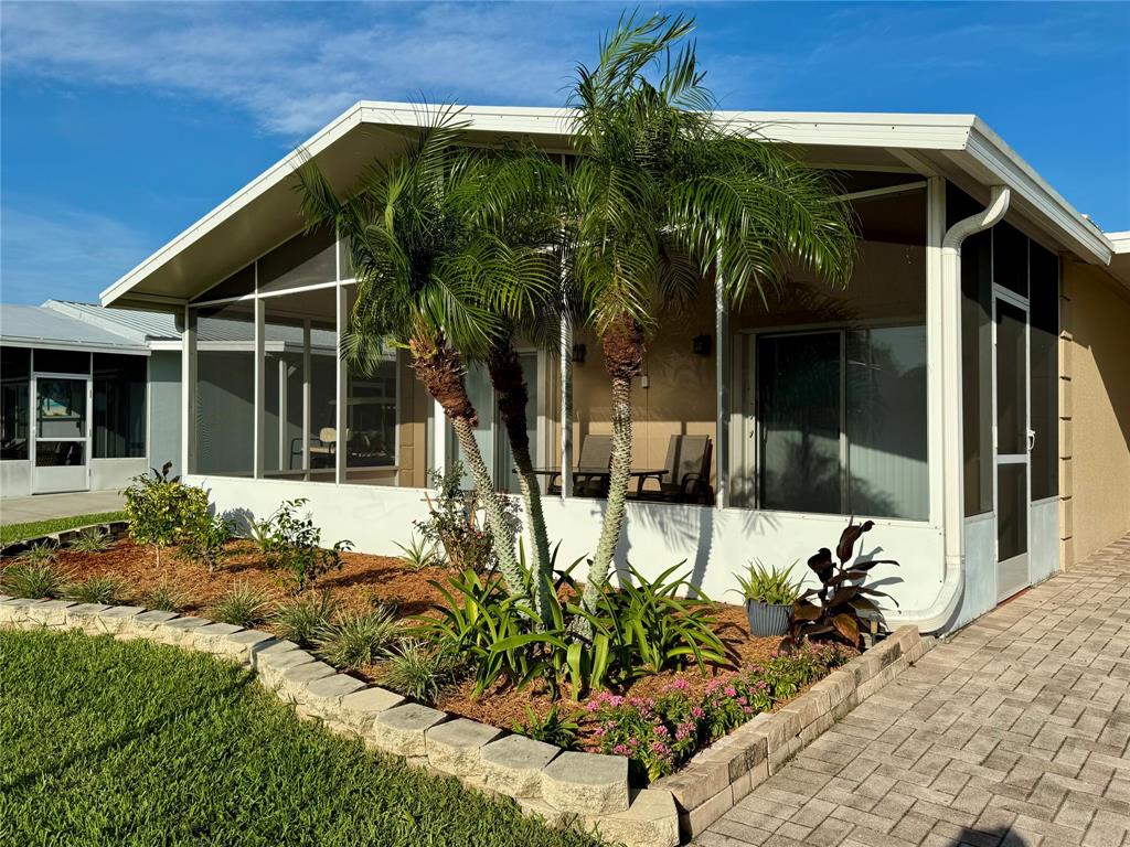 a view of a house with potted plants