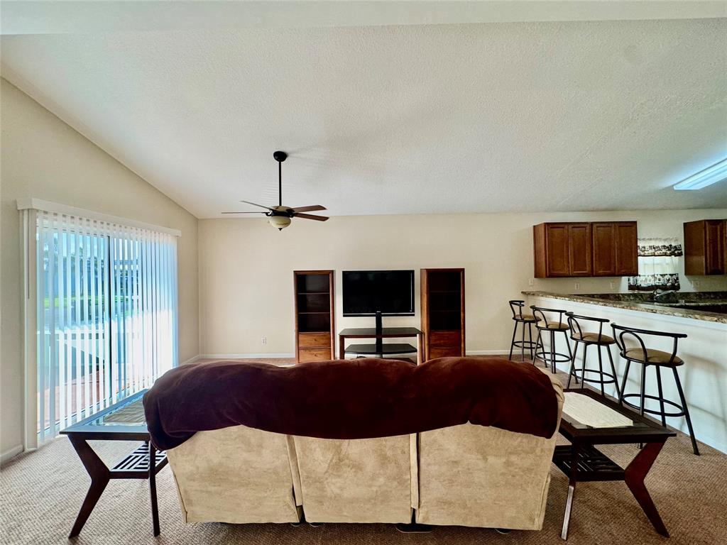 4301 Southwest 12th Way Okeechobee, FL 34974 - Photo 13 of 29 a living room with furniture and a flat screen tv
