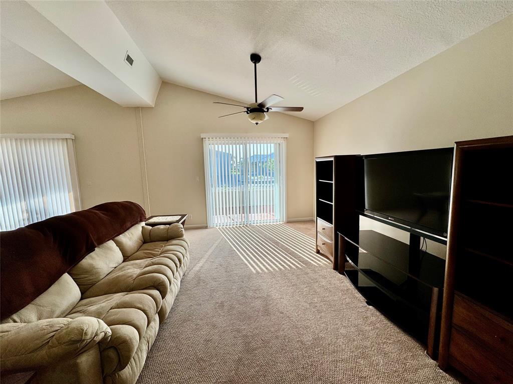 4301 Southwest 12th Way Okeechobee, FL 34974 - Photo 15 of 29 a living room with furniture a window and a flat screen tv