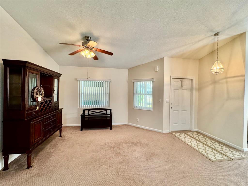 4301 Southwest 12th Way Okeechobee, FL 34974 - Photo 16 of 29 a living room with furniture and a flat screen tv