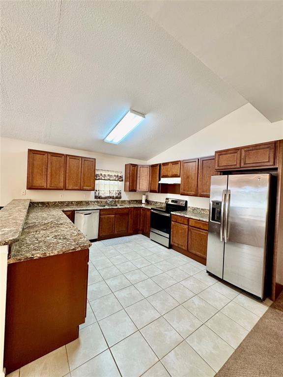 4301 Southwest 12th Way Okeechobee, FL 34974 - Photo 17 of 29 a kitchen with stainless steel appliances kitchen island granite countertop a sink counter space and stainless steel appliances