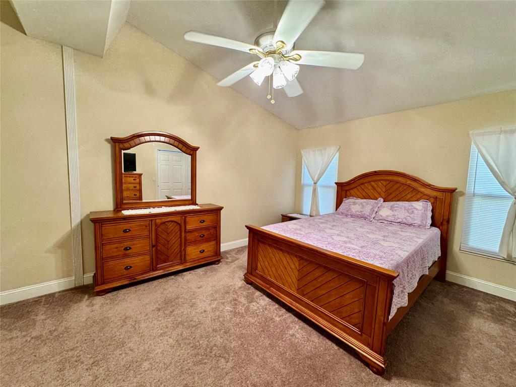 4301 Southwest 12th Way Okeechobee, FL 34974 - Photo 19 of 29 a bedroom with a bed and a dresser