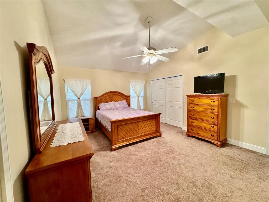 4301 Southwest 12th Way Okeechobee, FL 34974 - Photo 20 of 29 a bedroom with furniture and a flat tv screen