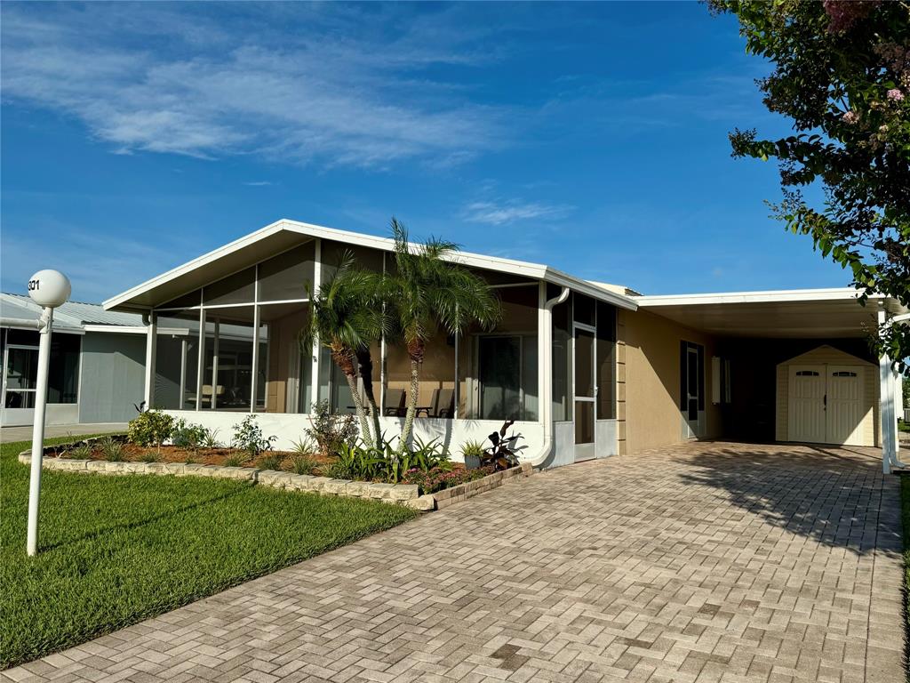 4301 Southwest 12th Way Okeechobee, FL 34974 - Photo 2 of 29 a front view of a house with garden