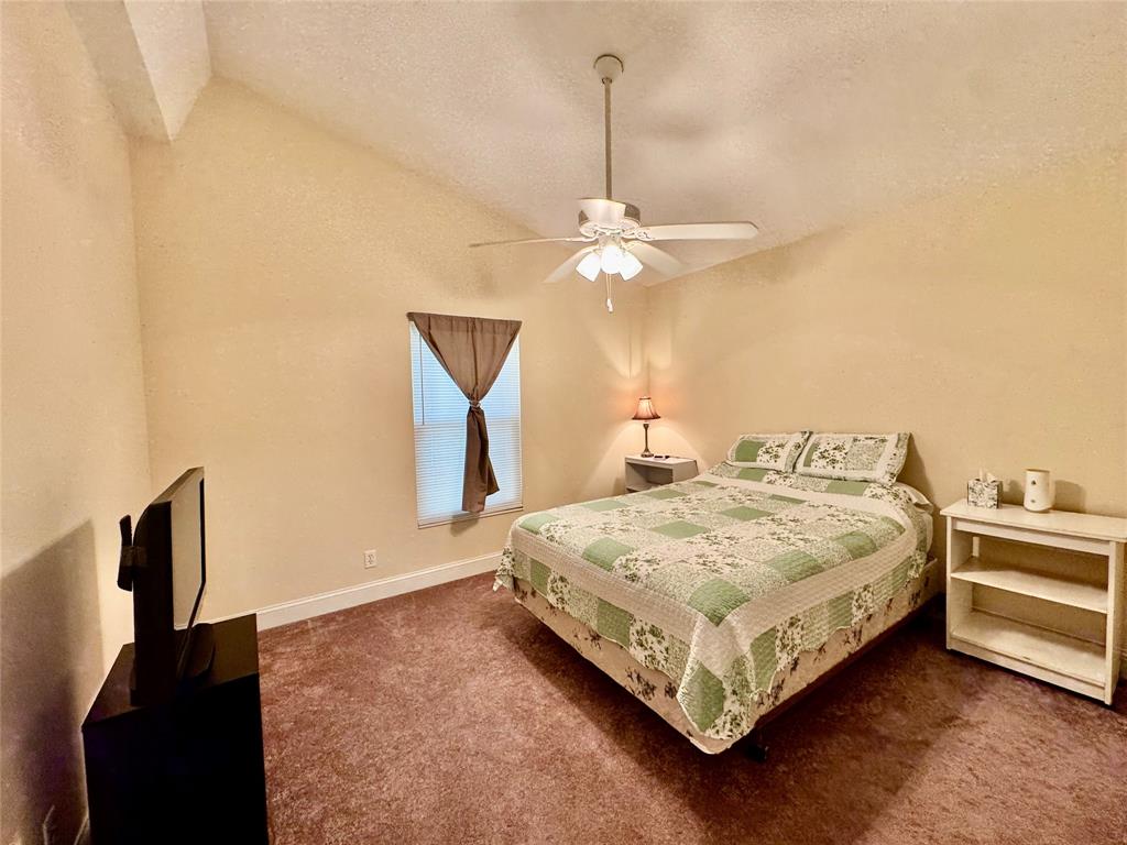 4301 Southwest 12th Way Okeechobee, FL 34974 - Photo 25 of 29 a bedroom with a bed and a chandelier