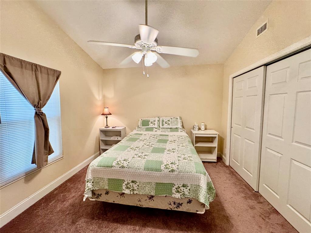 4301 Southwest 12th Way Okeechobee, FL 34974 - Photo 26 of 29 a bedroom with a bed and wooden floor