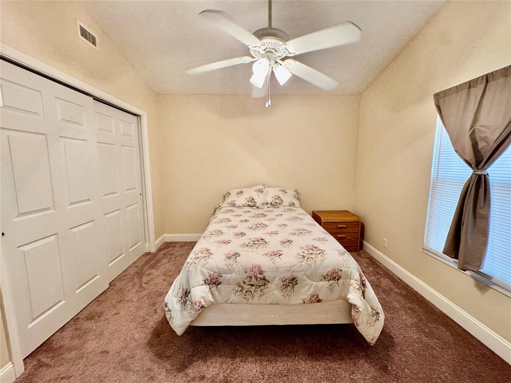 4301 Southwest 12th Way Okeechobee, FL 34974 - Photo 27 of 29 a bed sitting in a bedroom next to a window