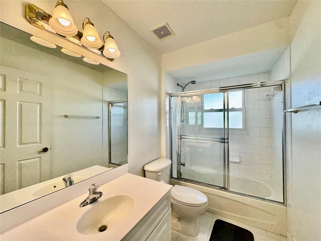 4301 Southwest 12th Way Okeechobee, FL 34974 - Photo 29 of 29 a bathroom with a sink a toilet and shower