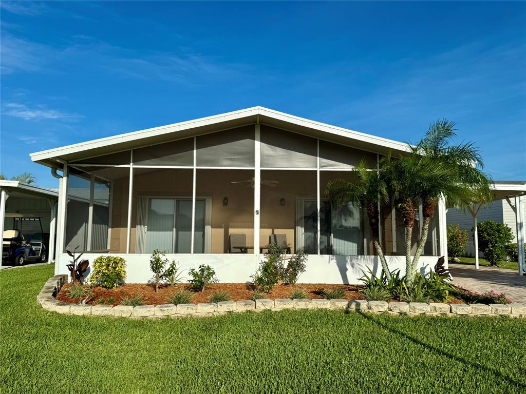 4301 Southwest 12th Way Okeechobee, FL 34974 - Photo 3 of 29 a front view of a house with a yard table and chairs