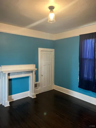 a view of empty room with a fireplace