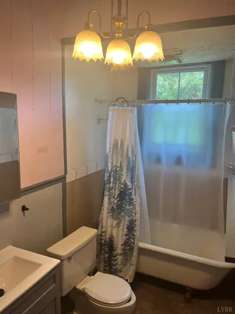 a bathroom with a toilet and shower