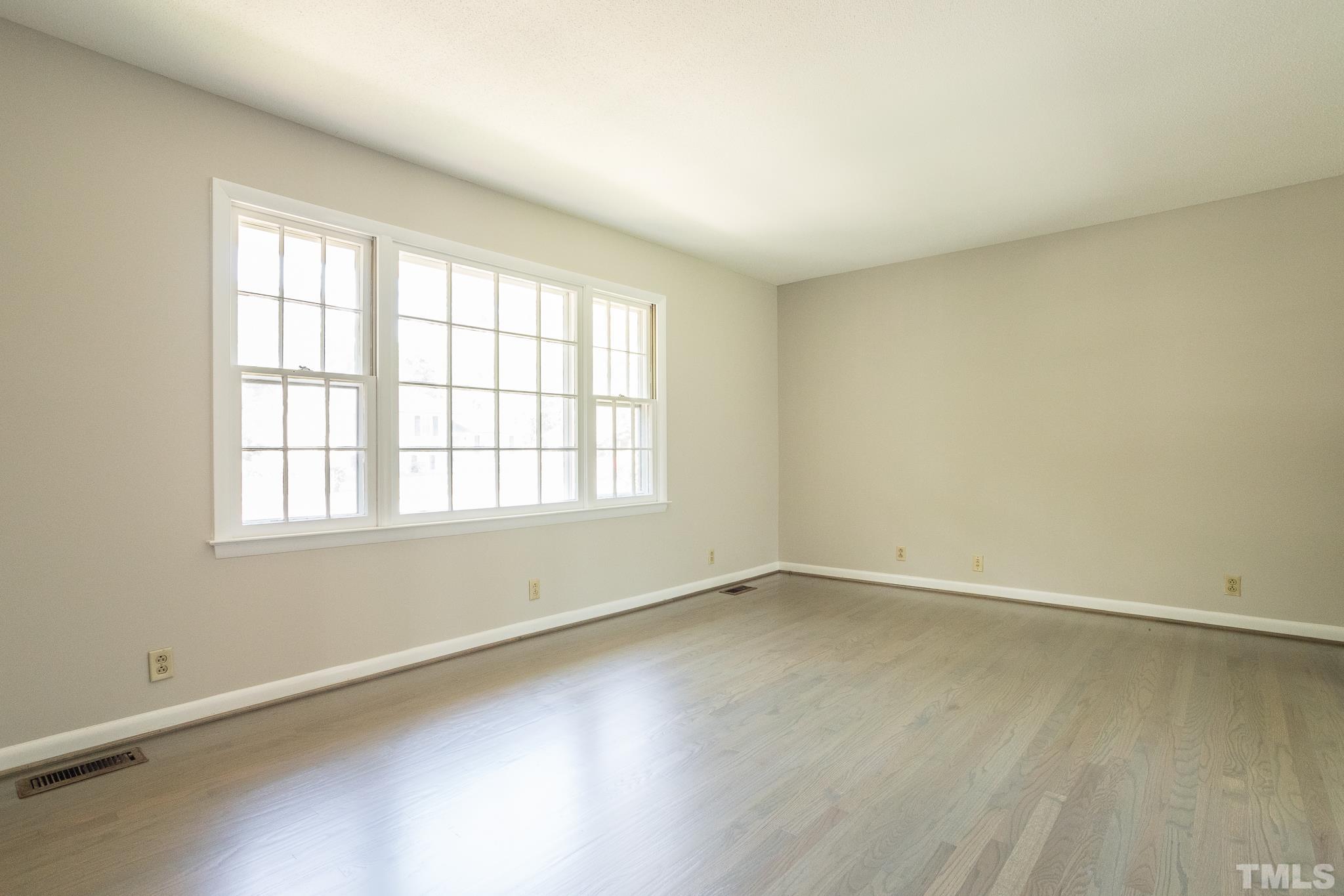 3715 Tulane Drive Raleigh, NC 27604 - Photo 14 of 39 an empty room with wooden floor and windows