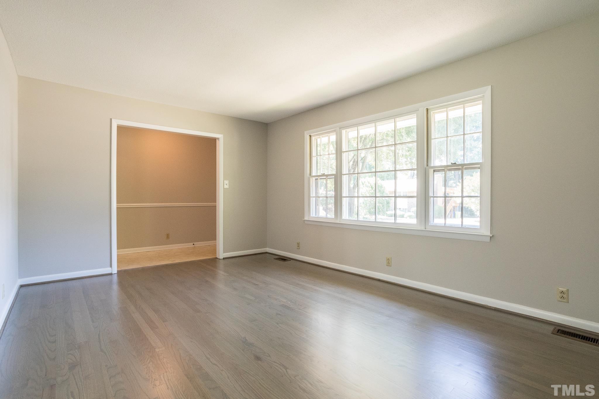 3715 Tulane Drive Raleigh, NC 27604 - Photo 17 of 39 an empty room with wooden floor and windows