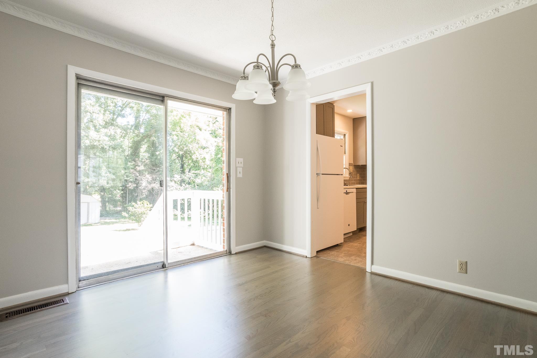 3715 Tulane Drive Raleigh, NC 27604 - Photo 18 of 39 a view of an empty room with wooden floor and a window