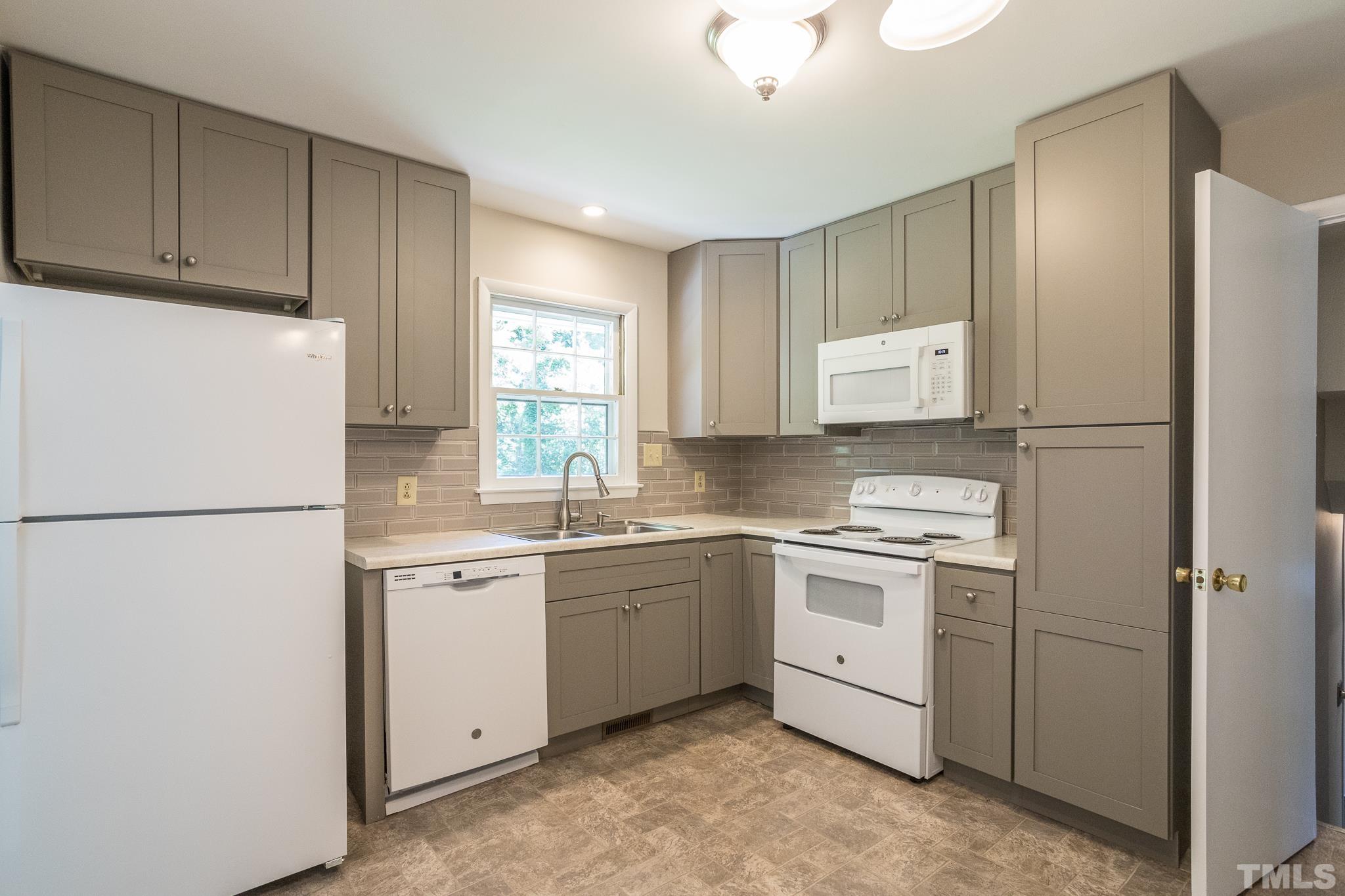 3715 Tulane Drive Raleigh, NC 27604 - Photo 22 of 39 a kitchen with a white cabinets and refrigerator