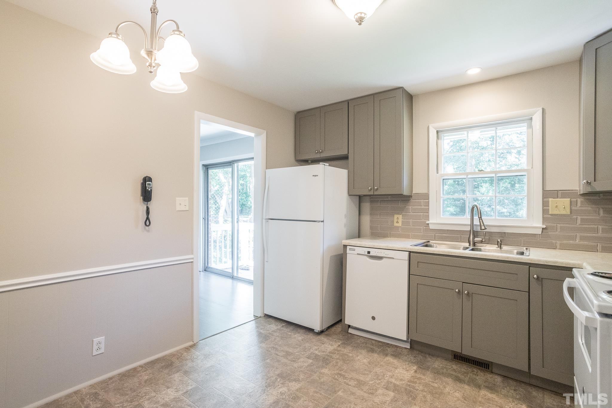 3715 Tulane Drive Raleigh, NC 27604 - Photo 23 of 39 a kitchen with a sink a refrigerator and window