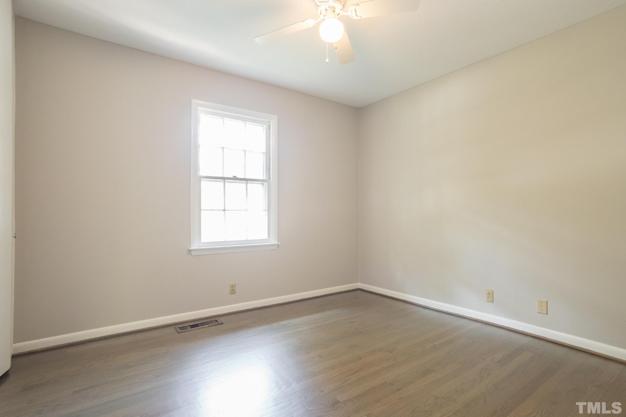 3715 Tulane Drive Raleigh, NC 27604 - Photo 25 of 39 an empty room with wooden floor and windows