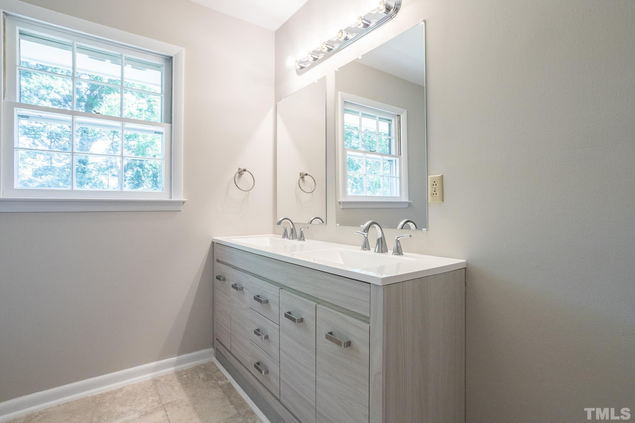 3715 Tulane Drive Raleigh, NC 27604 - Photo 31 of 39 a bathroom with 2 sink and a mirror