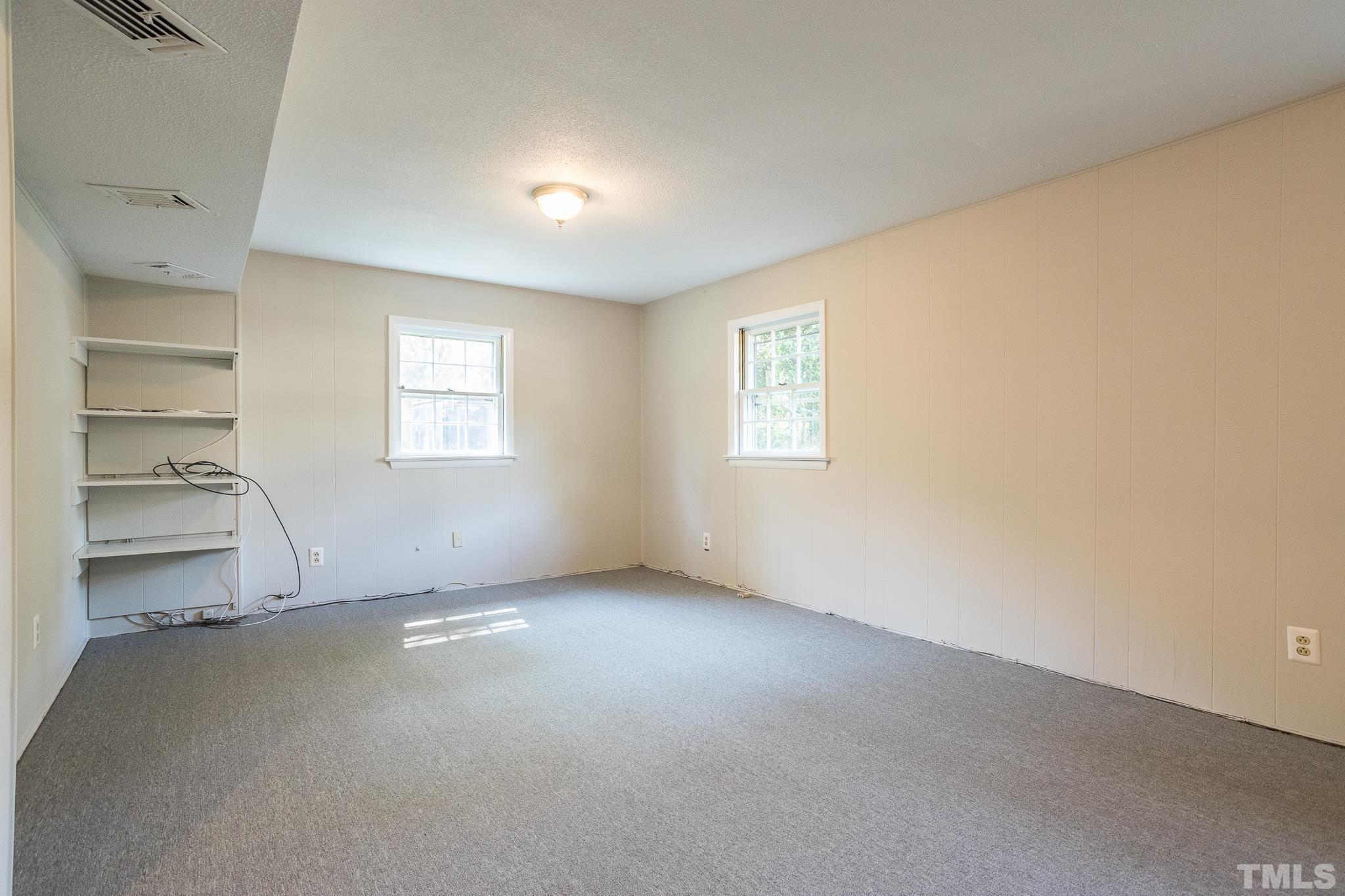 3715 Tulane Drive Raleigh, NC 27604 - Photo 32 of 39 an empty room with a fireplace and windows
