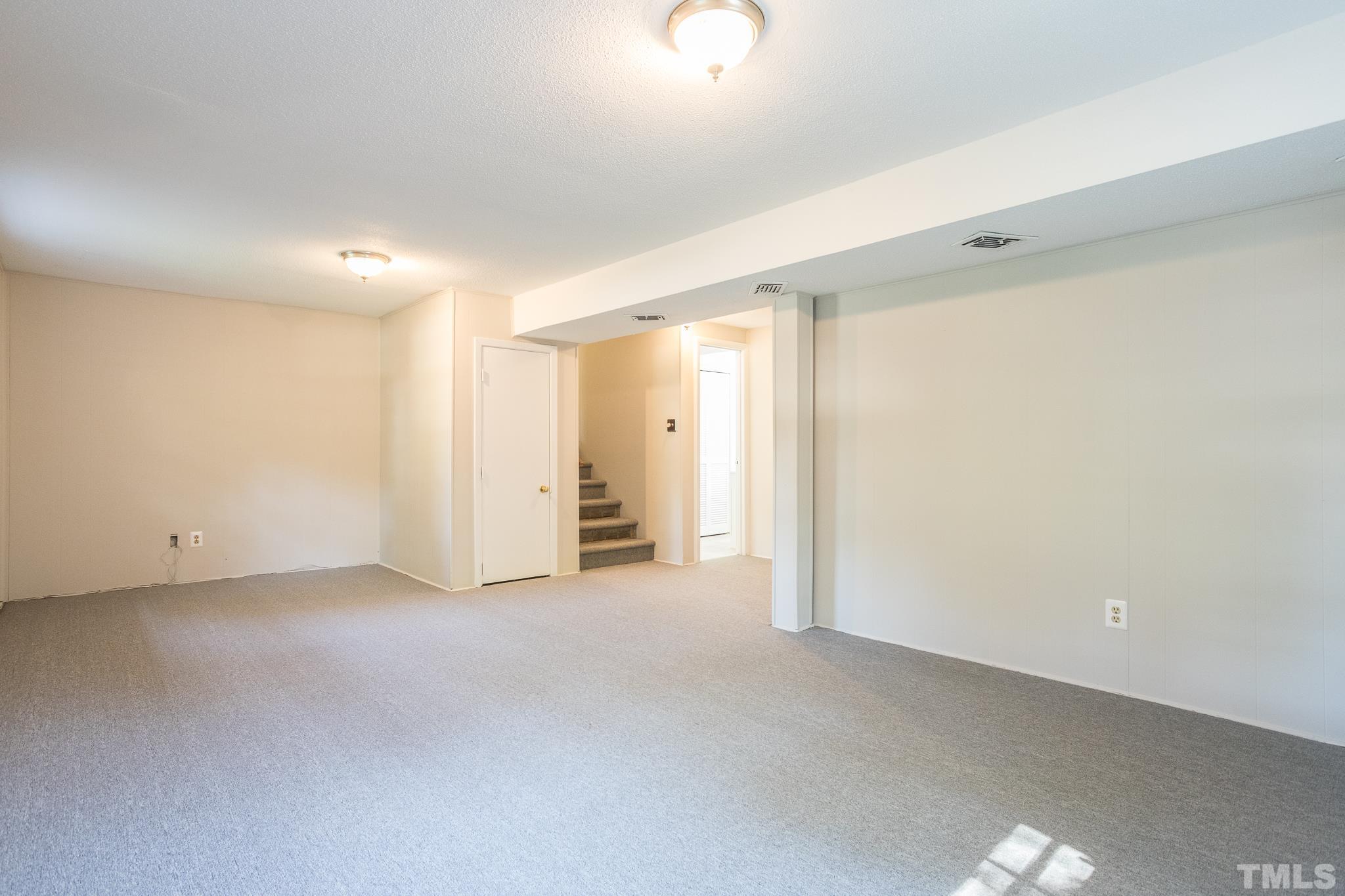 3715 Tulane Drive Raleigh, NC 27604 - Photo 34 of 39 an empty room with white cabinet and mirrors