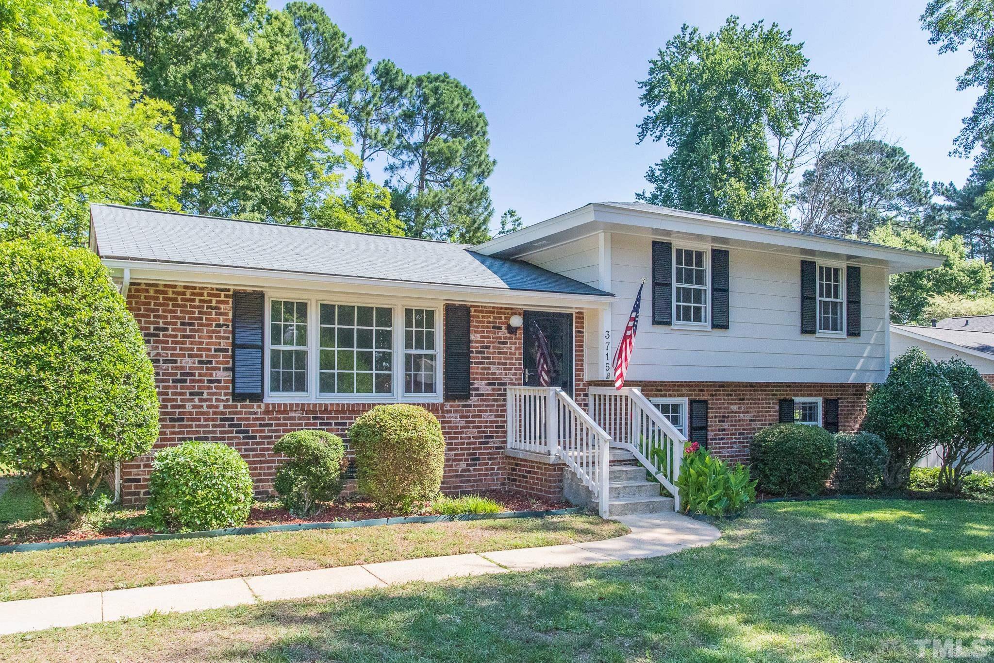 3715 Tulane Drive Raleigh, NC 27604 - Photo 4 of 39 a front view of a house with a garden and yard