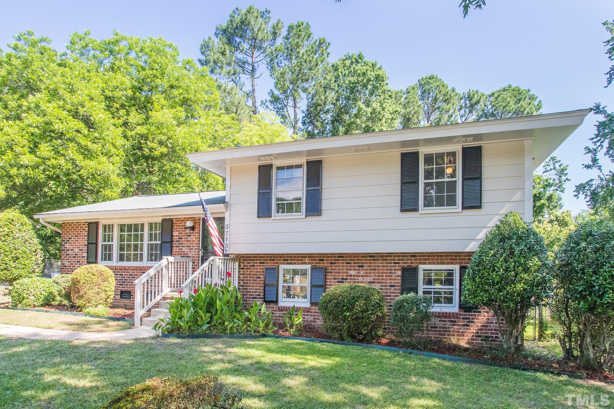 3715 Tulane Drive Raleigh, NC 27604 - Photo 5 of 39 a front view of a house with a yard and potted plants