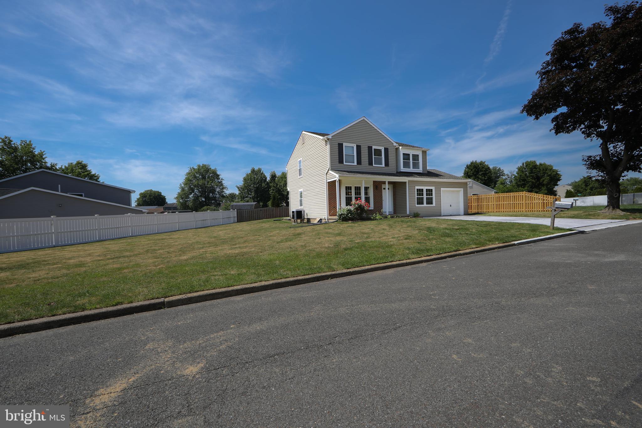 3007 Rampart Road Bensalem, PA 19020 - Photo 6 of 48 a front view of a house with a yard and garage